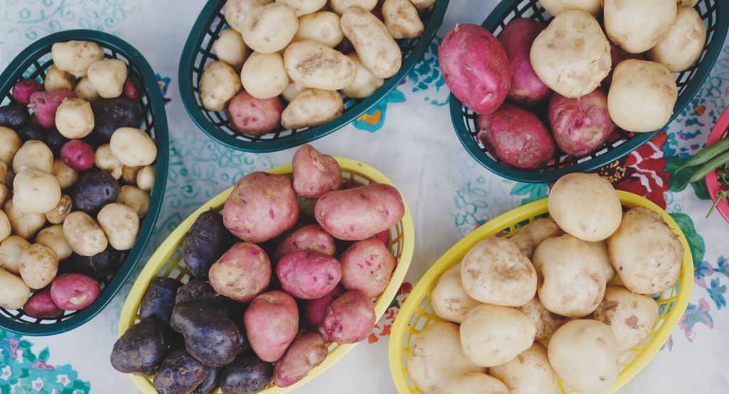 raw potatoes in baskets